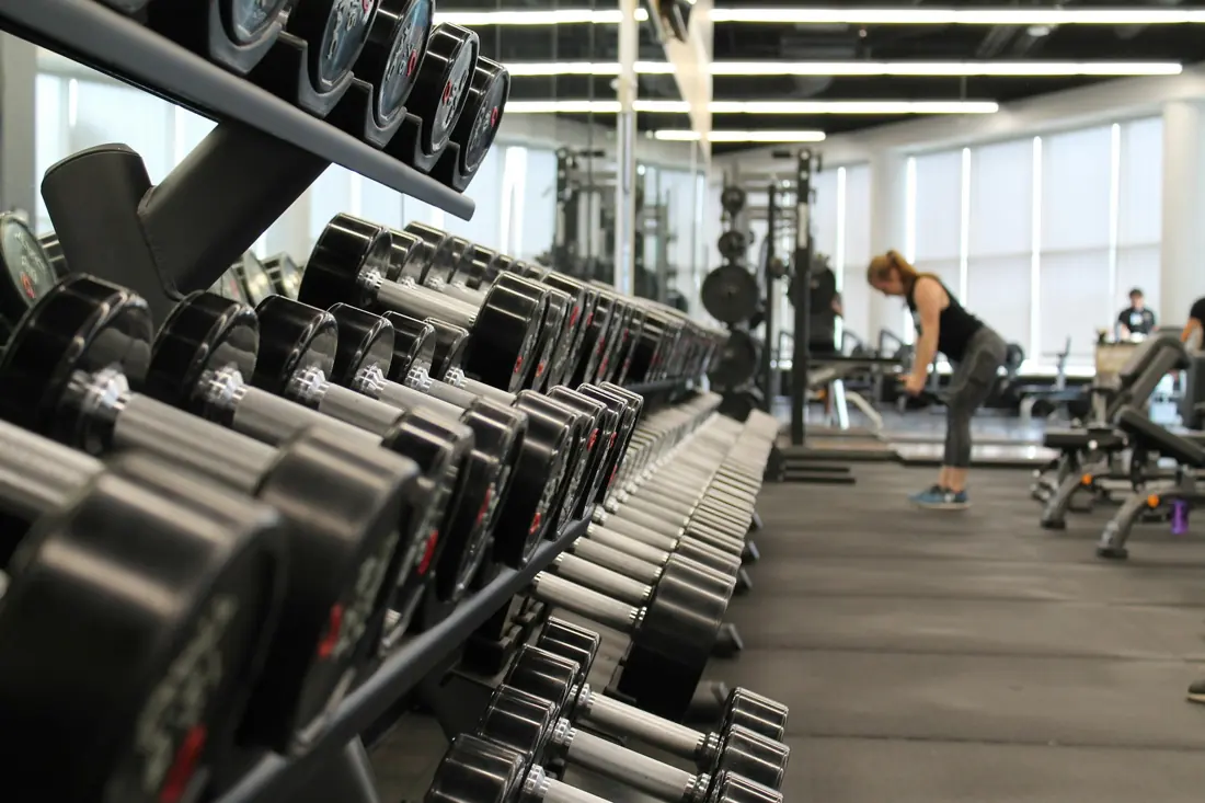 A gym floor with dumbbell racks